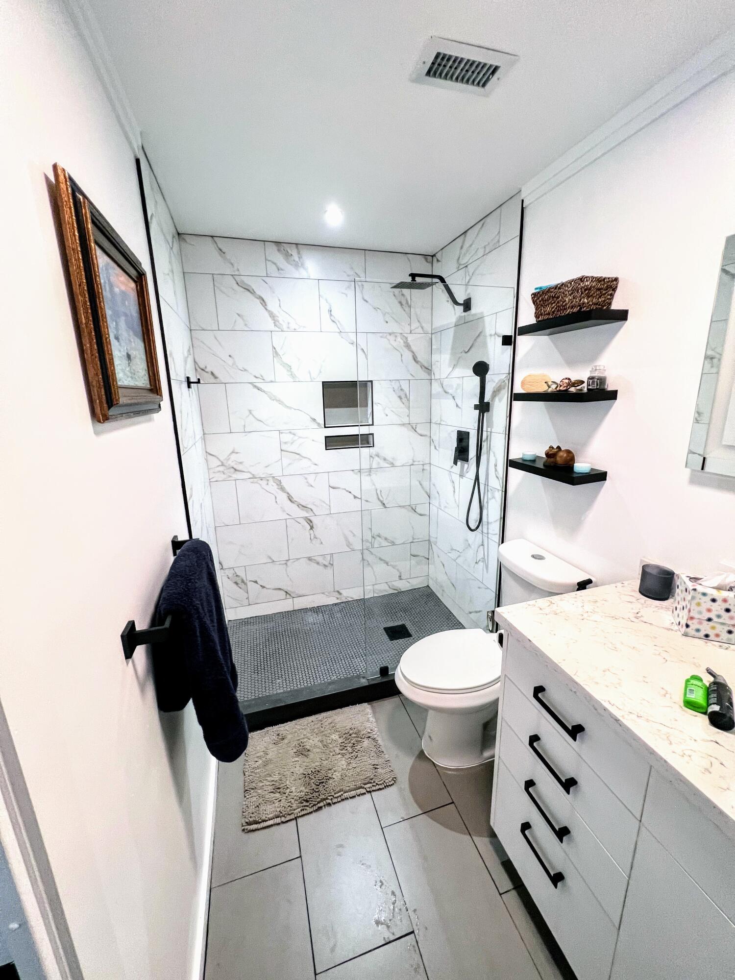 469 Northeast 30th Street Boca Raton, FL 33431 - Photo 12 of 24 a bathroom with a sink a toilet and shower