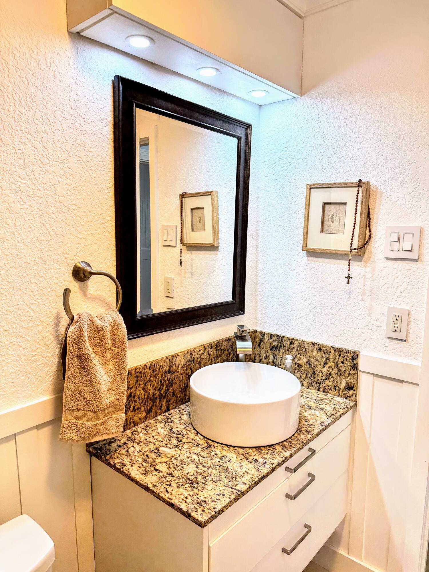 469 Northeast 30th Street Boca Raton, FL 33431 - Photo 16 of 24 a bathroom with a sink and a mirror
