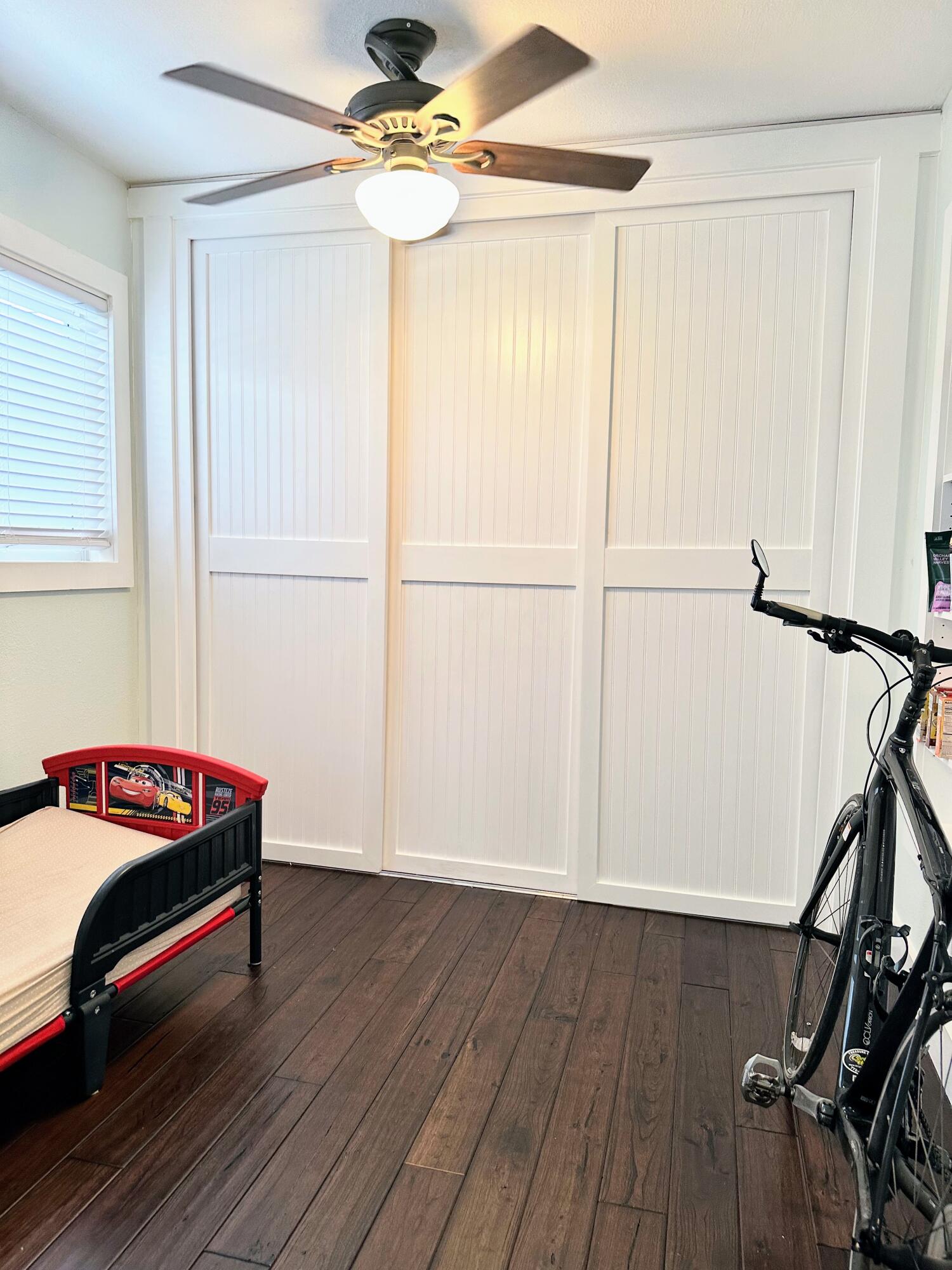 469 Northeast 30th Street Boca Raton, FL 33431 - Photo 18 of 24 a hallway with a hardwood floor and a ceiling fan