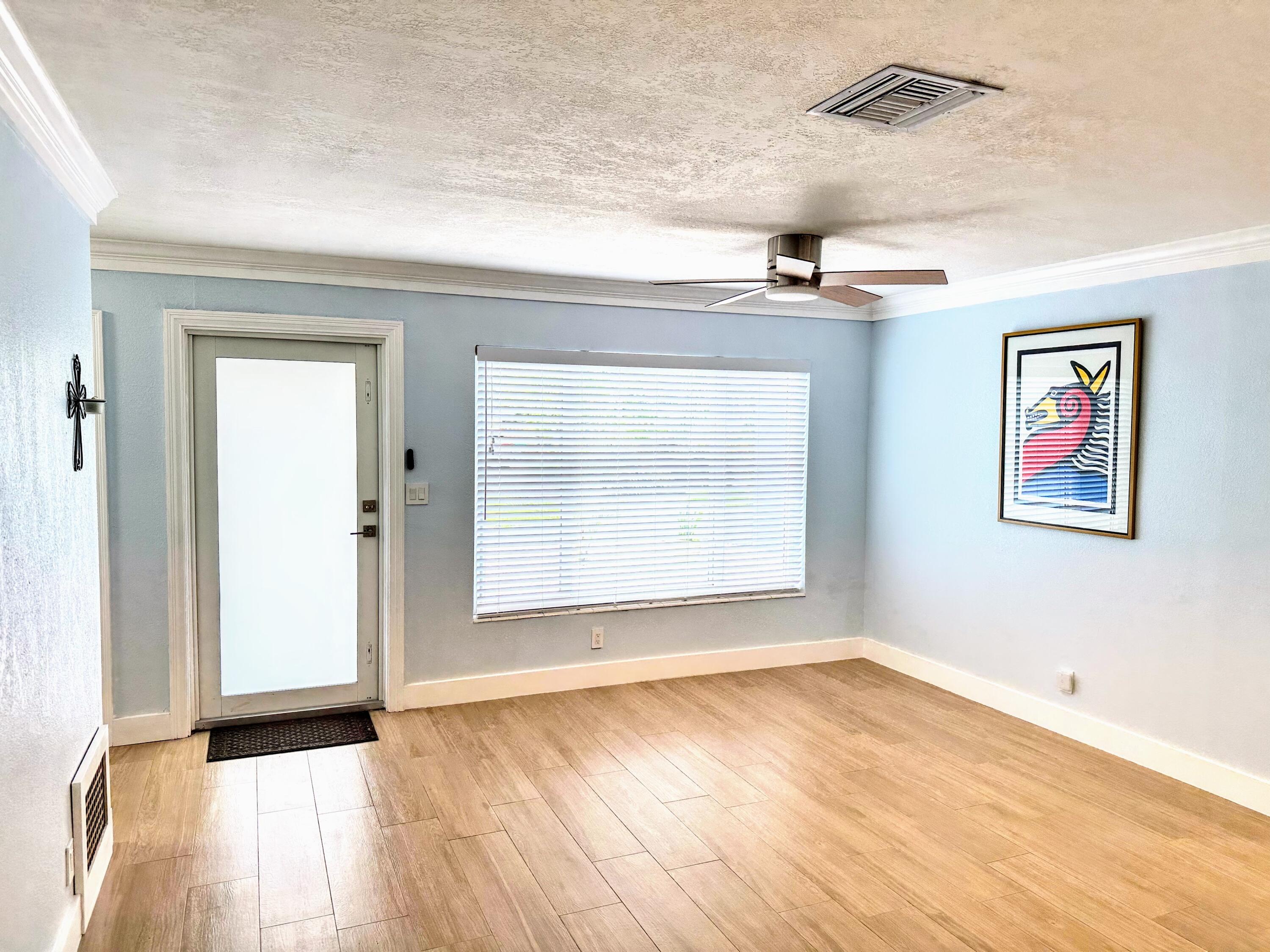 469 Northeast 30th Street Boca Raton, FL 33431 - Photo 5 of 24 an empty room with a window and wooden floor