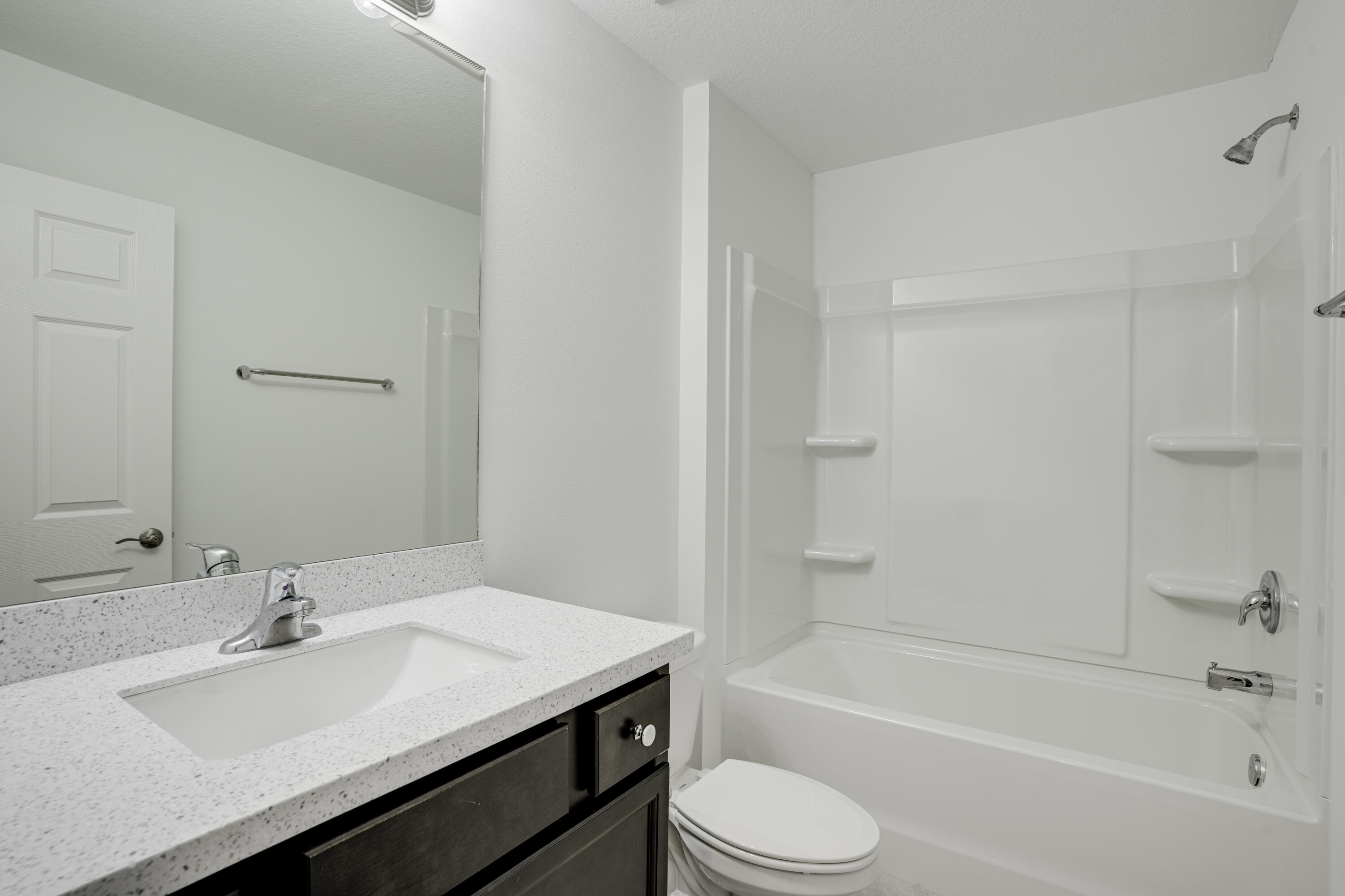 5264 Southeast 43rd Street Okeechobee, FL 34974 - Photo 14 of 16 a bathroom with a bathtub sink vanity mirror and toilet