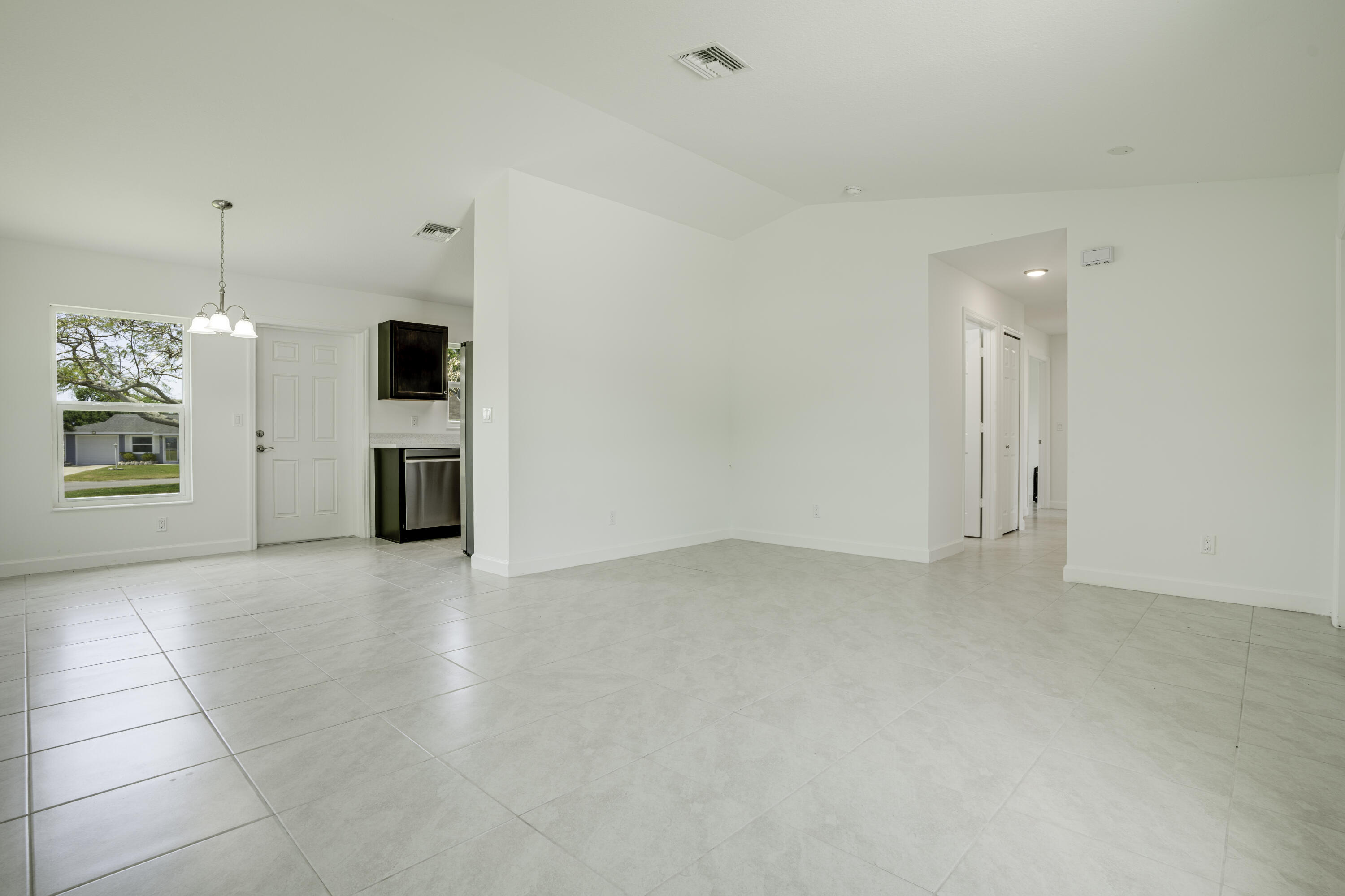 5264 Southeast 43rd Street Okeechobee, FL 34974 - Photo 3 of 16 a view of a kitchen with a sink and a refrigerator