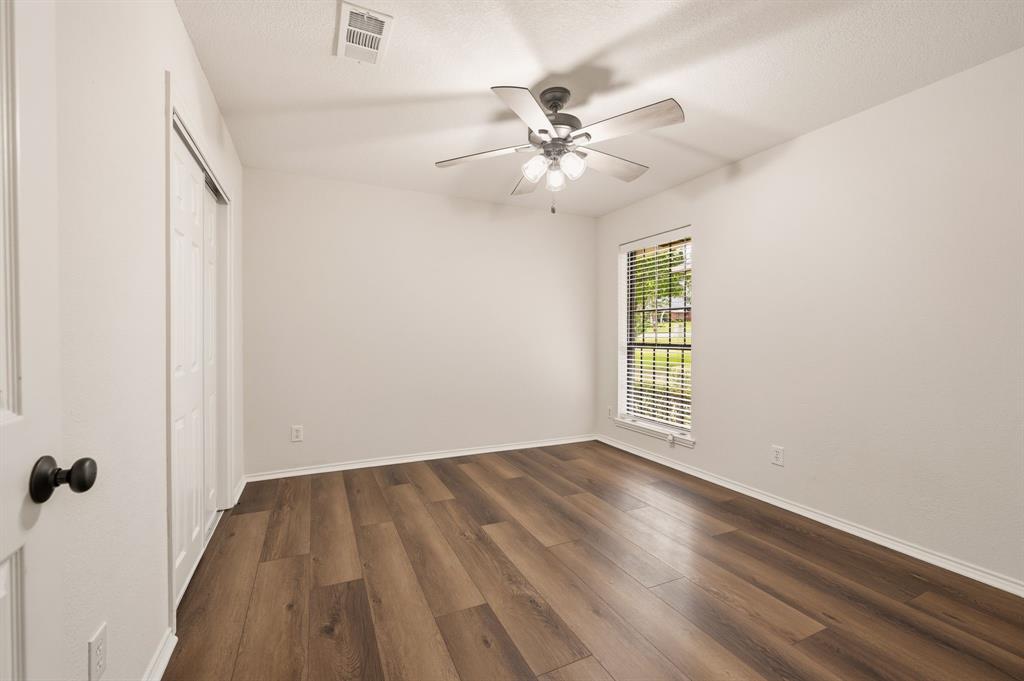 1805 Renfro Road Colleyville, TX 76034 - Photo 21 of 40 Bright interior space featuring wood-finish flooring, a ceiling fan with integrated lighting, and a window with horizontal blinds