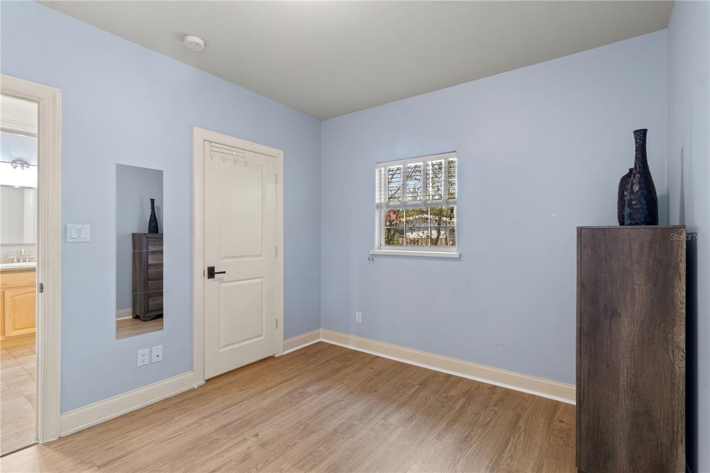 6515 Dimarco Road Tampa, FL 33634 - Photo 62 of 66 a view of an empty room with wooden floor and a window