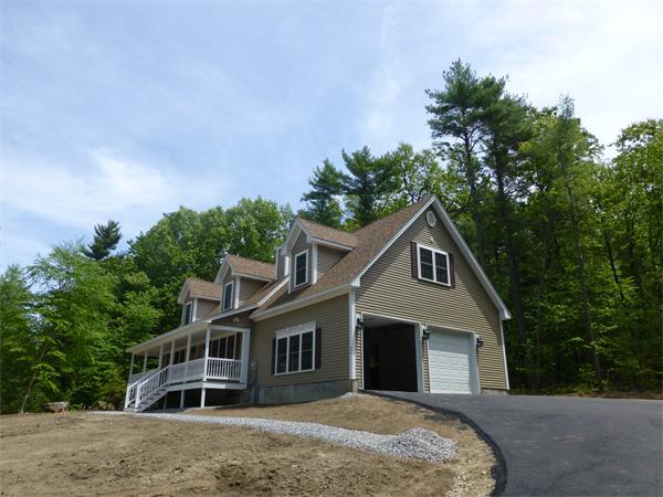 92 Kendall Road Holden, MA 01520 - Photo 1 of 12 a front view of a house with a yard and trees