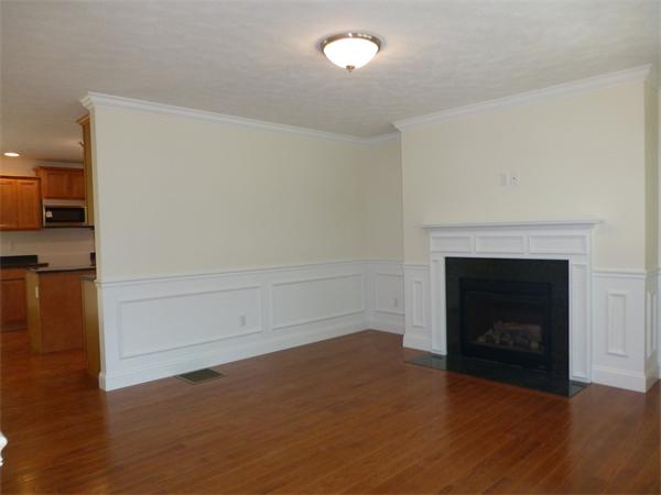 92 Kendall Road Holden, MA 01520 - Photo 2 of 12 a view of a livingroom with an empty space and a fireplace