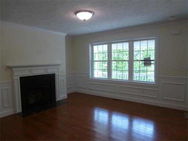 92 Kendall Road Holden, MA 01520 - Photo 3 of 12 a view of an empty room with wooden floor and a window