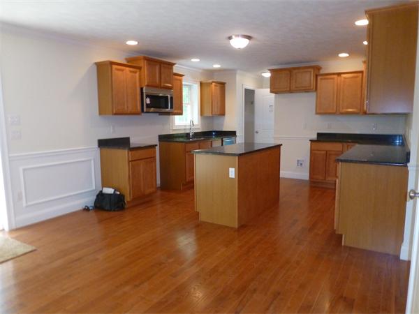 92 Kendall Road Holden, MA 01520 - Photo 4 of 12 a kitchen with stainless steel appliances granite countertop a stove a sink and a microwave