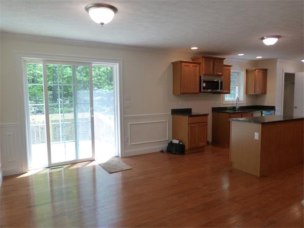 92 Kendall Road Holden, MA 01520 - Photo 5 of 12 a kitchen with stainless steel appliances granite countertop a stove top oven a sink a refrigerator and white cabinets with wooden floor