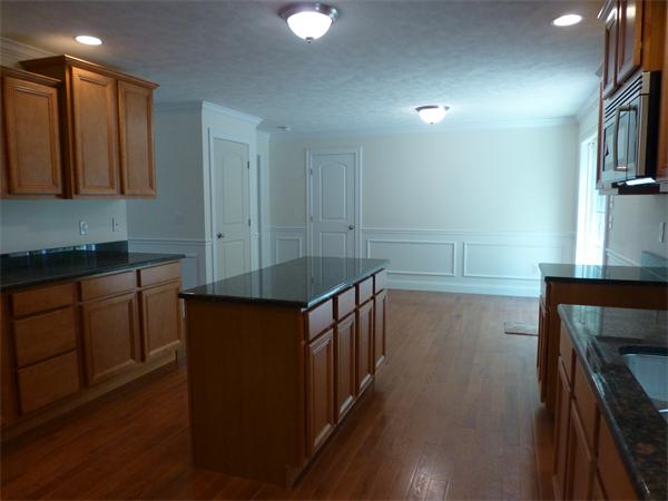 92 Kendall Road Holden, MA 01520 - Photo 7 of 12 a kitchen with sink cabinets and wooden floor