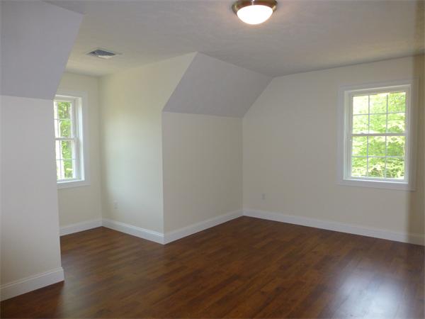 92 Kendall Road Holden, MA 01520 - Photo 8 of 12 a view of an empty room with wooden floor and a window