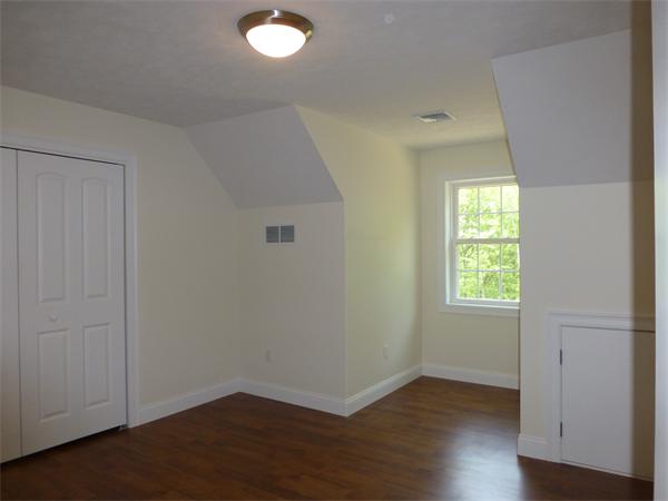 92 Kendall Road Holden, MA 01520 - Photo 10 of 12 an empty room with wooden floor and windows