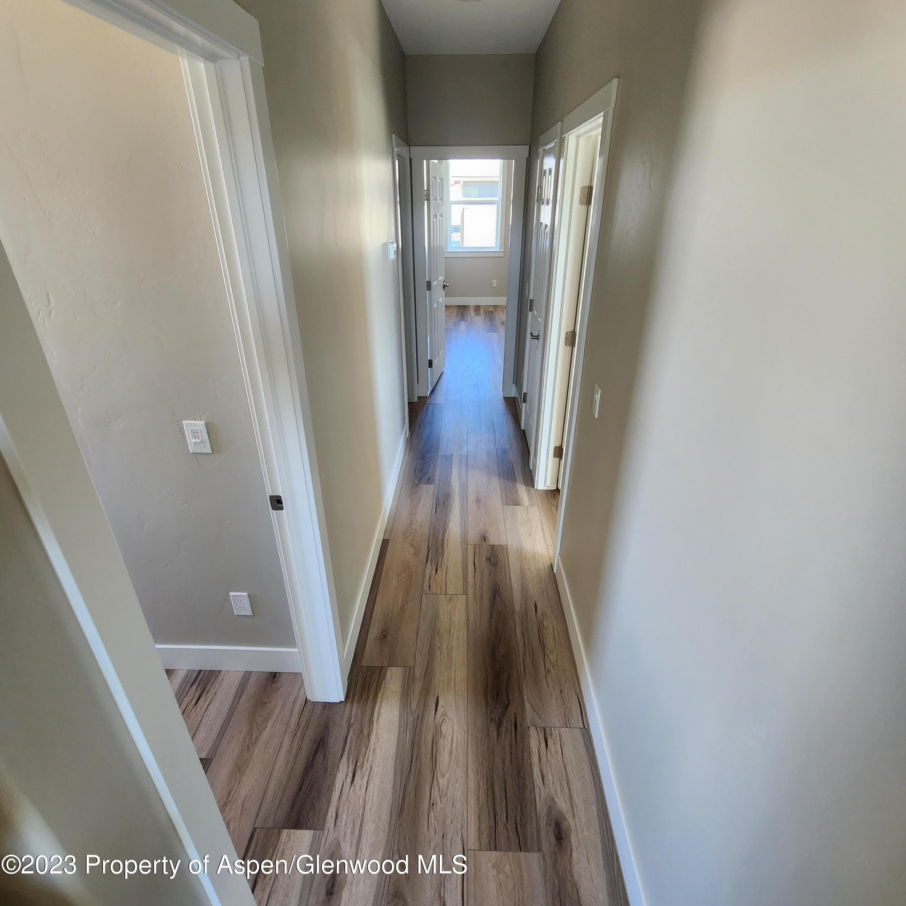 890 East 16th Street Rifle, CO 81650 - Photo 11 of 17 a view of a hallway with wooden floor and staircase