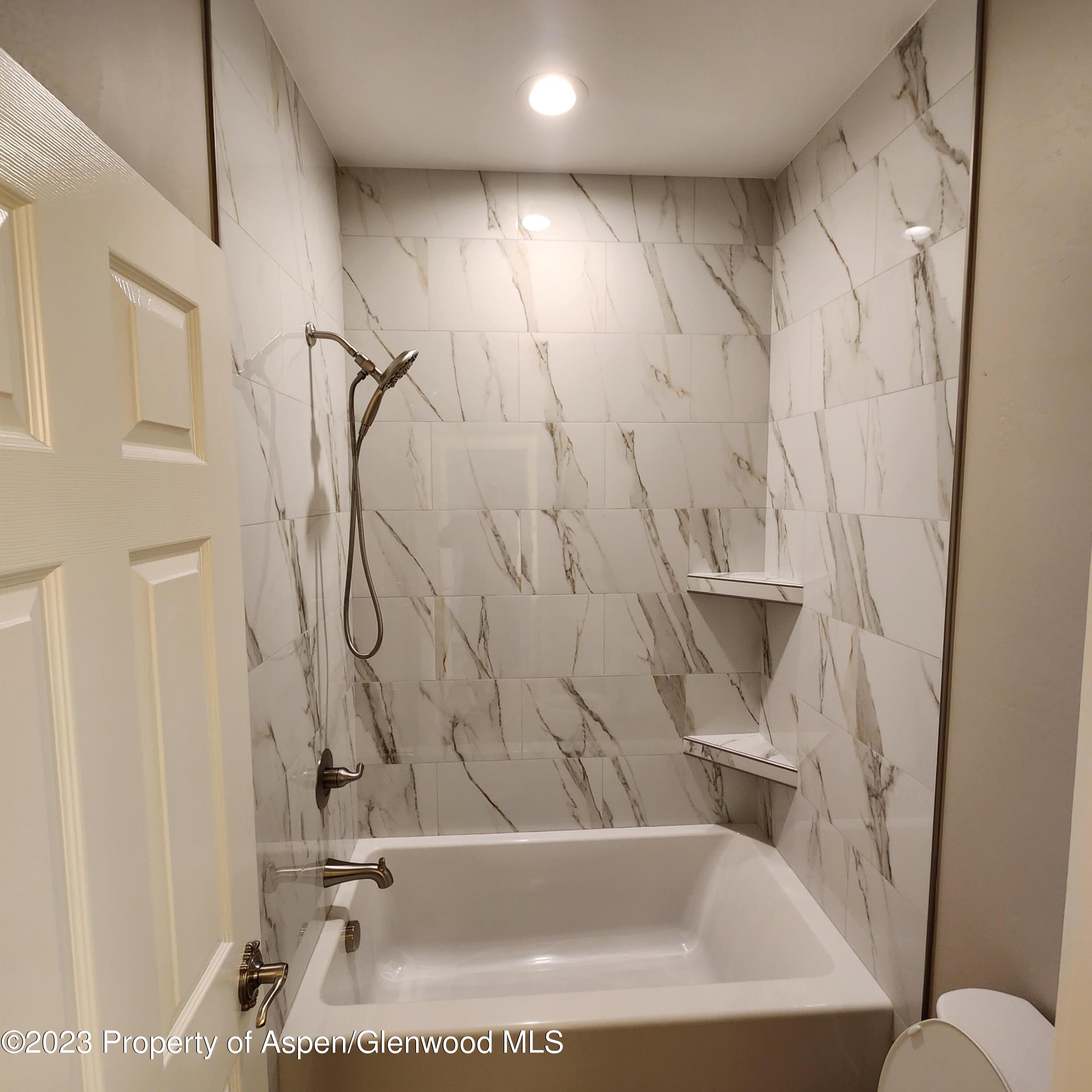 890 East 16th Street Rifle, CO 81650 - Photo 12 of 17 a bathroom with a tub and a shower