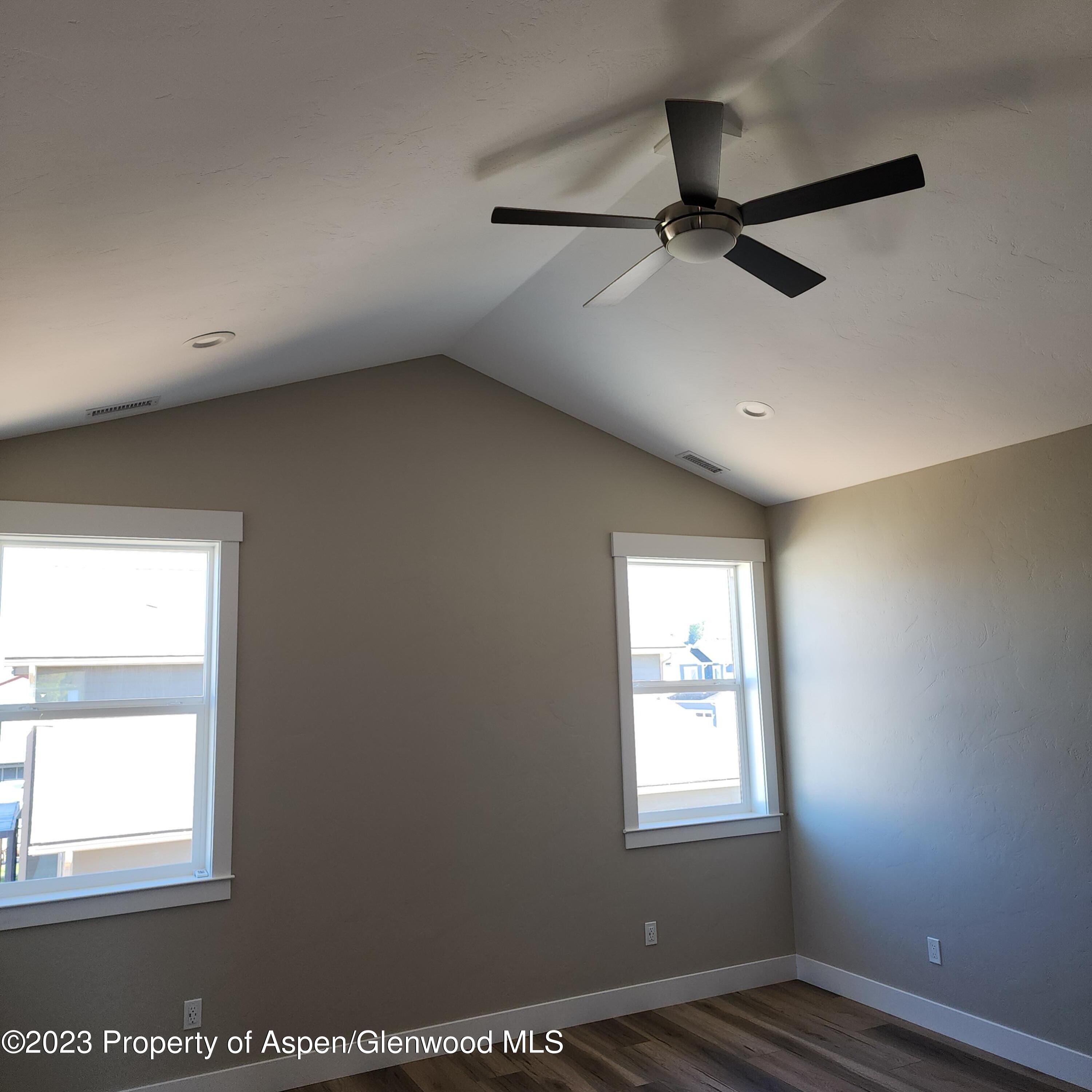 890 East 16th Street Rifle, CO 81650 - Photo 13 of 17 an empty room with wooden floor fan and windows