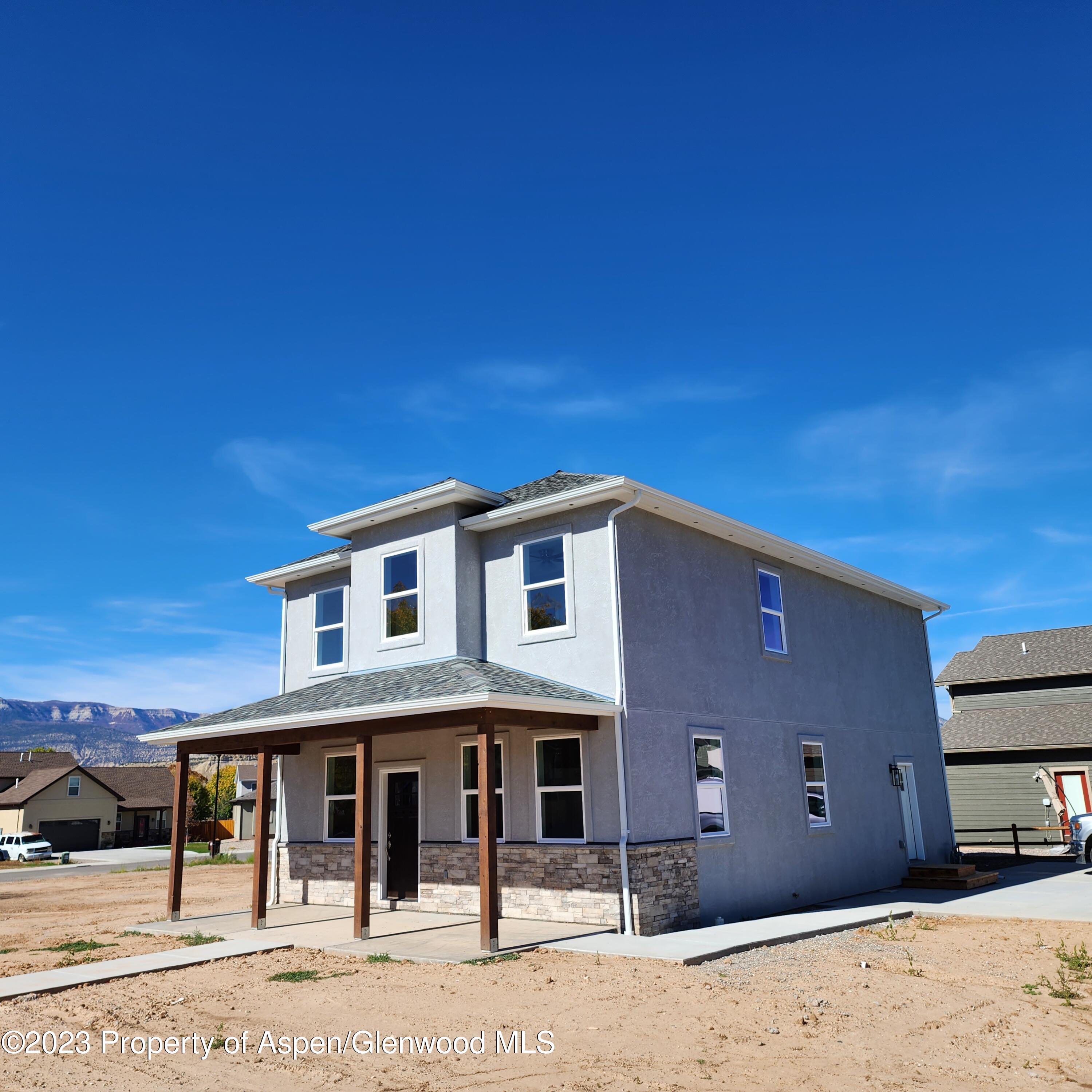 890 East 16th Street Rifle, CO 81650 - Photo 3 of 17 a front view of a house with a yard