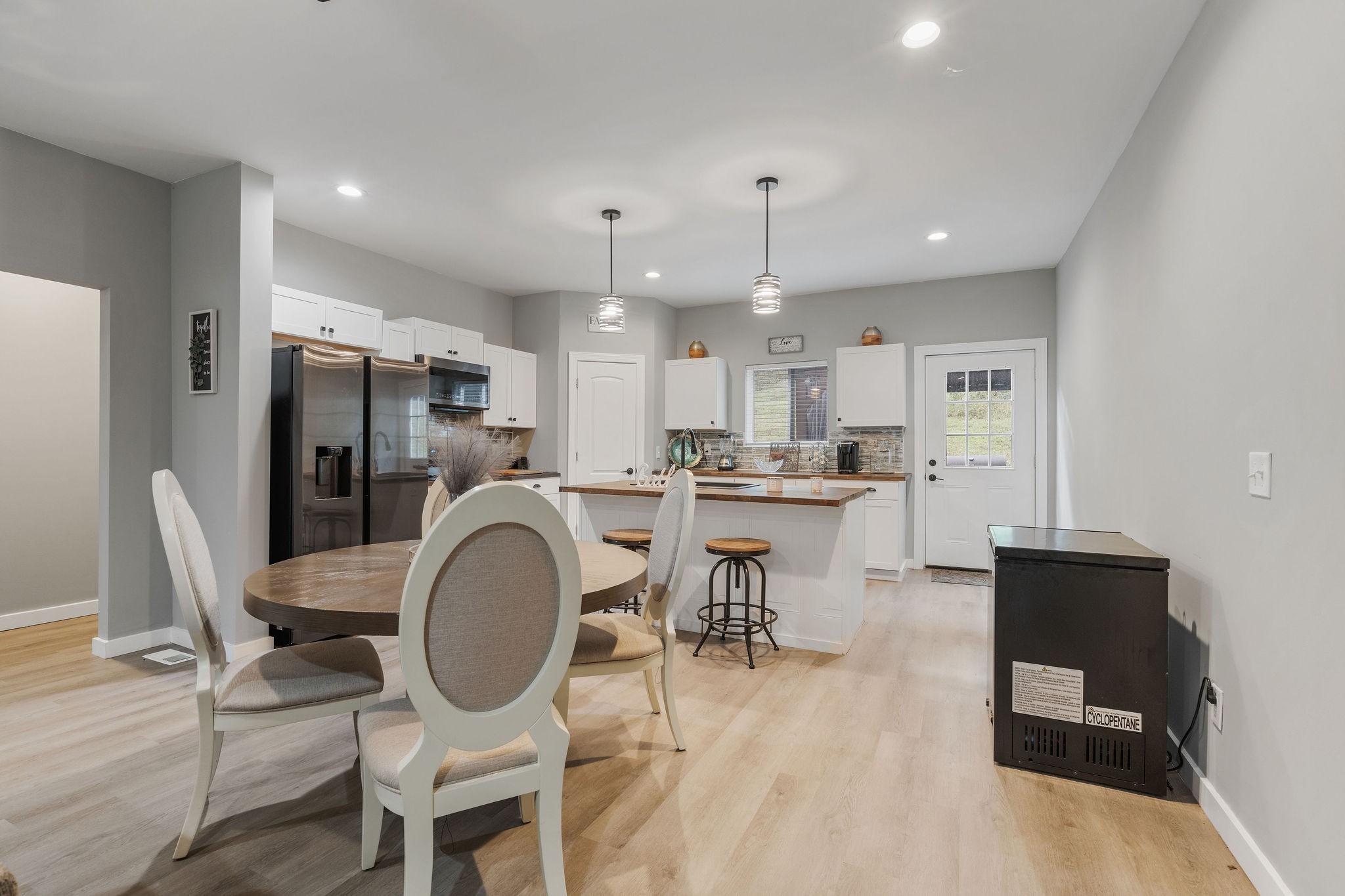 286 Emily Lane Bell Buckle, TN 37020 - Photo 18 of 38 a kitchen with stainless steel appliances kitchen island granite countertop a dining table chairs and a refrigerator