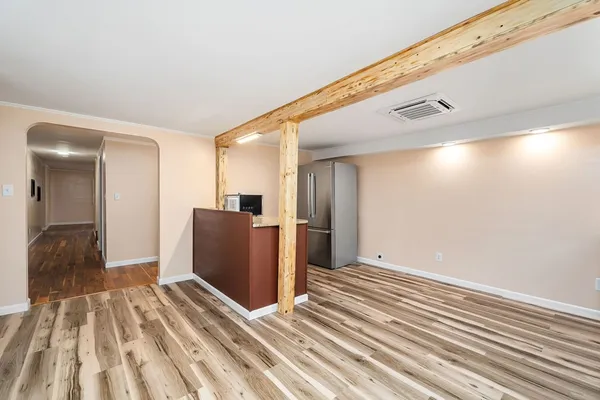 a view of a livingroom with wooden floor and a staircase