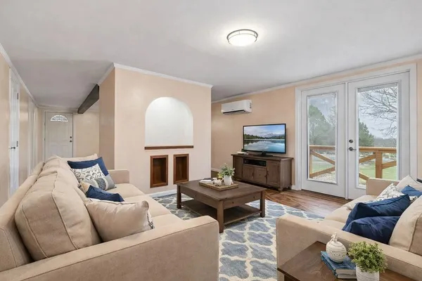 a living room with furniture a fireplace and a flat screen tv
