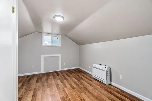 a view of a room with wooden floor and white walls