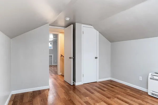 a view of hallway with wooden floor