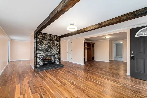 wooden floor in an empty room with a fireplace