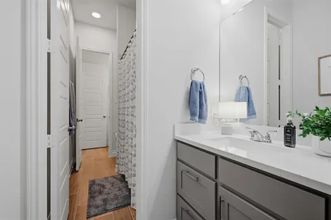 a bathroom with a shower sink and mirror