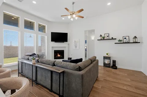 a living room with furniture fireplace and a flat screen tv