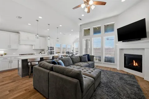 a living room with furniture fireplace and flat screen tv