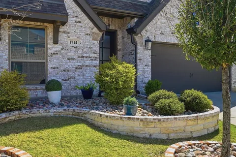 a front view of a house with swimming pool and yard