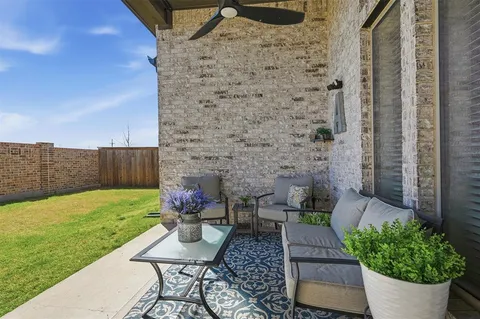 a view of a backyard with chair and a garden