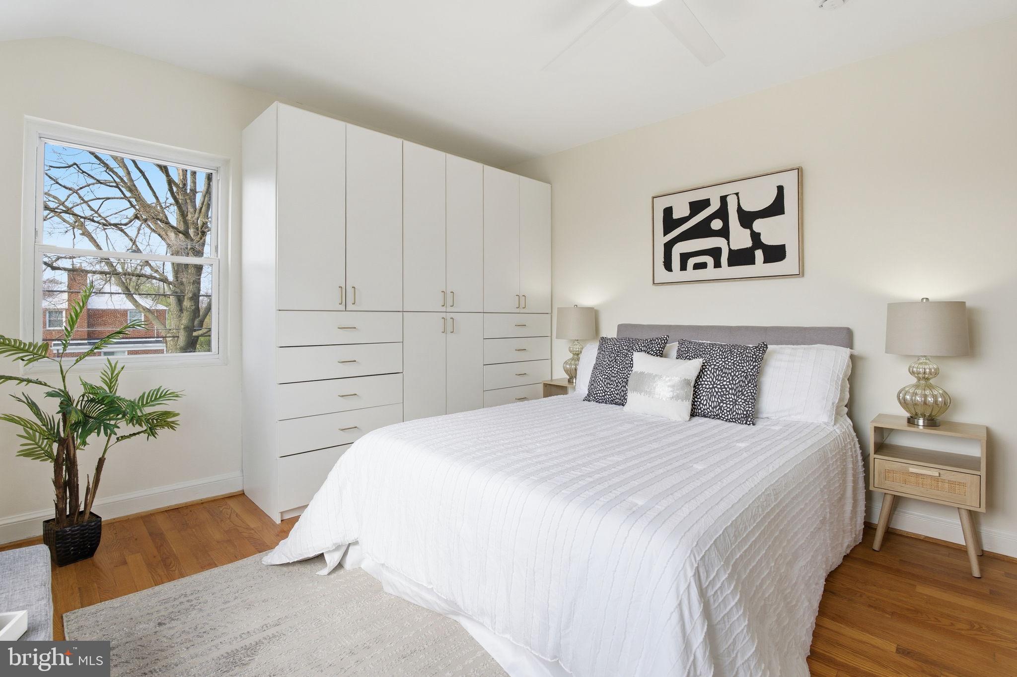 11527 Grandview Avenue Silver Spring, MD 20902 - Photo 14 of 36 a bedroom with a bed and a potted plant