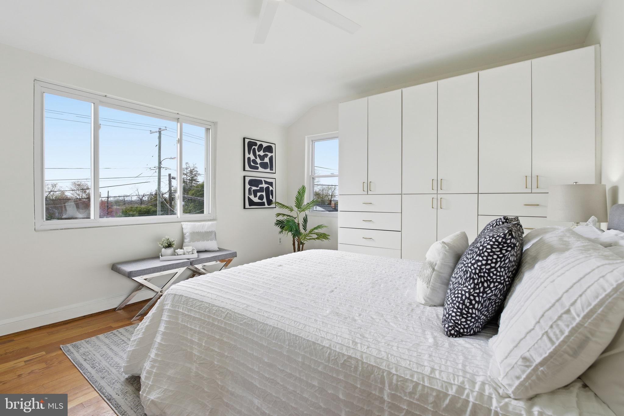 11527 Grandview Avenue Silver Spring, MD 20902 - Photo 16 of 36 a bedroom with a bed a table and windows