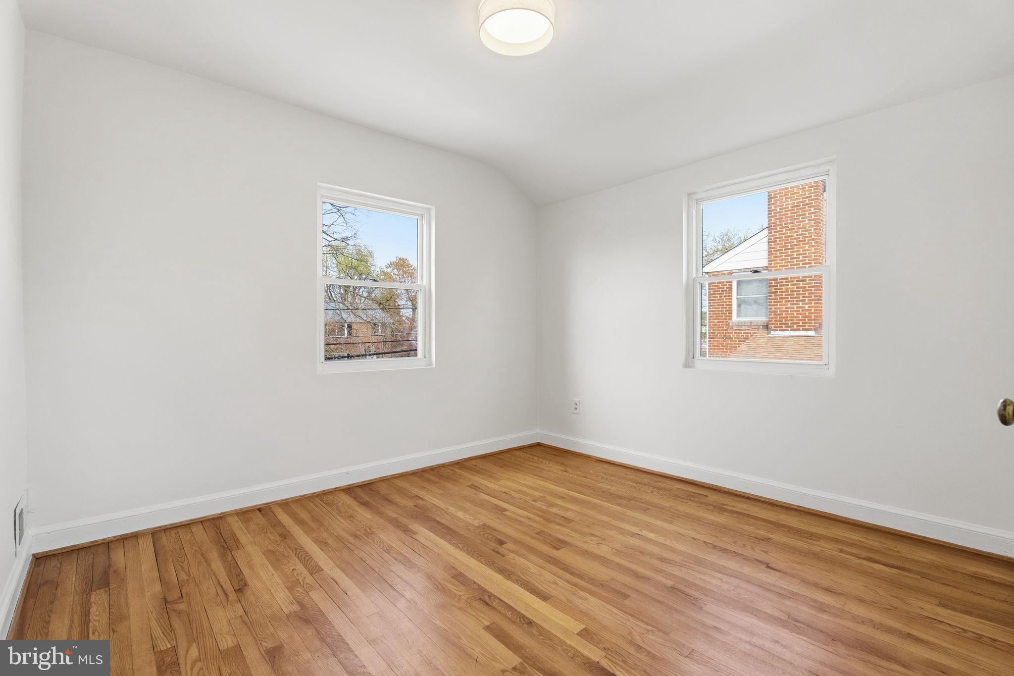 11527 Grandview Avenue Silver Spring, MD 20902 - Photo 18 of 36 a view of an empty room with wooden floor and a window