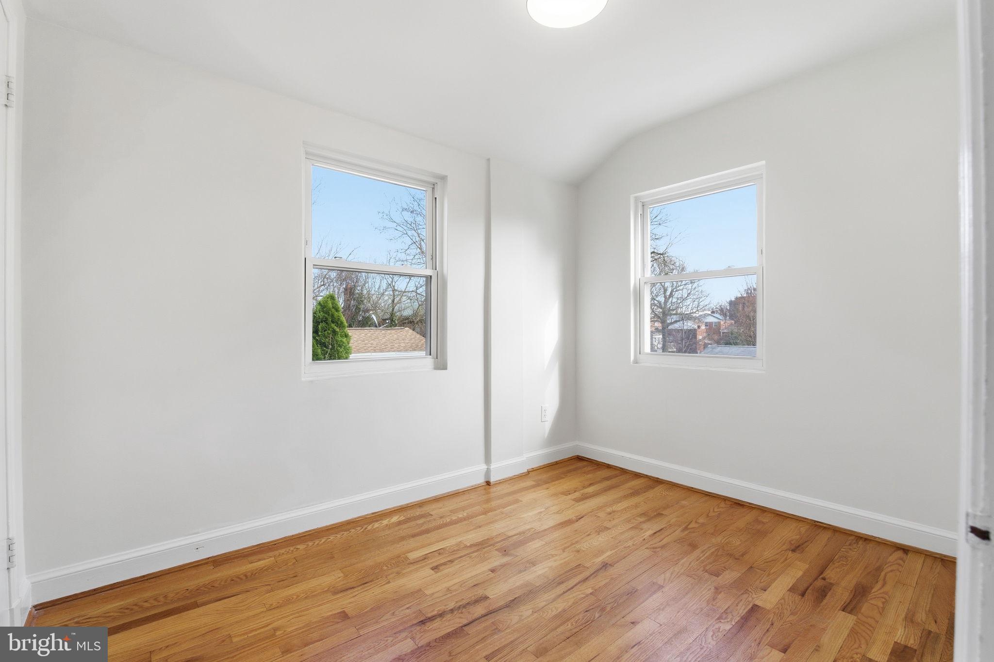 11527 Grandview Avenue Silver Spring, MD 20902 - Photo 20 of 36 a view of an empty room with wooden floor and a window