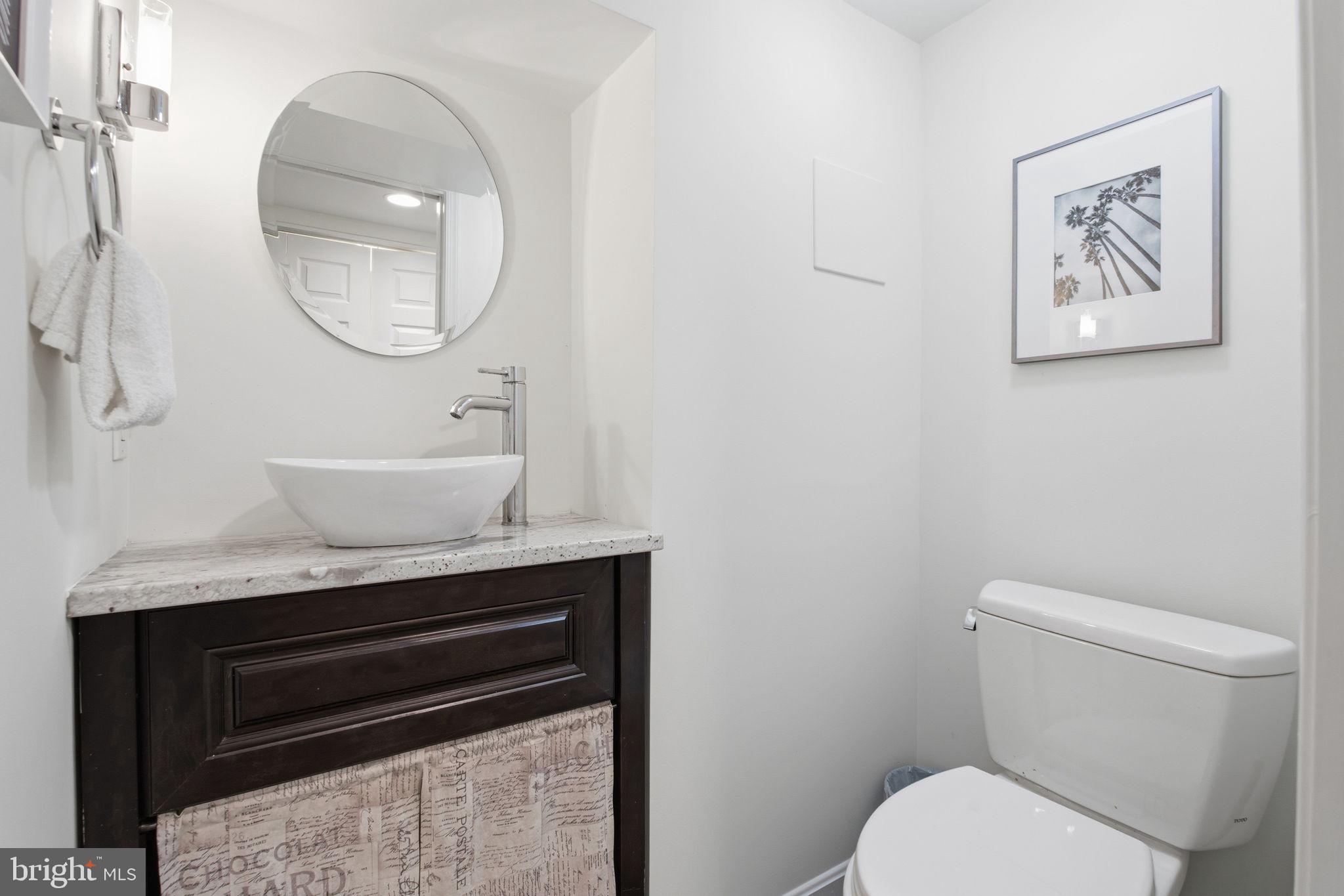 11527 Grandview Avenue Silver Spring, MD 20902 - Photo 22 of 36 a bathroom with a toilet a sink and a mirror