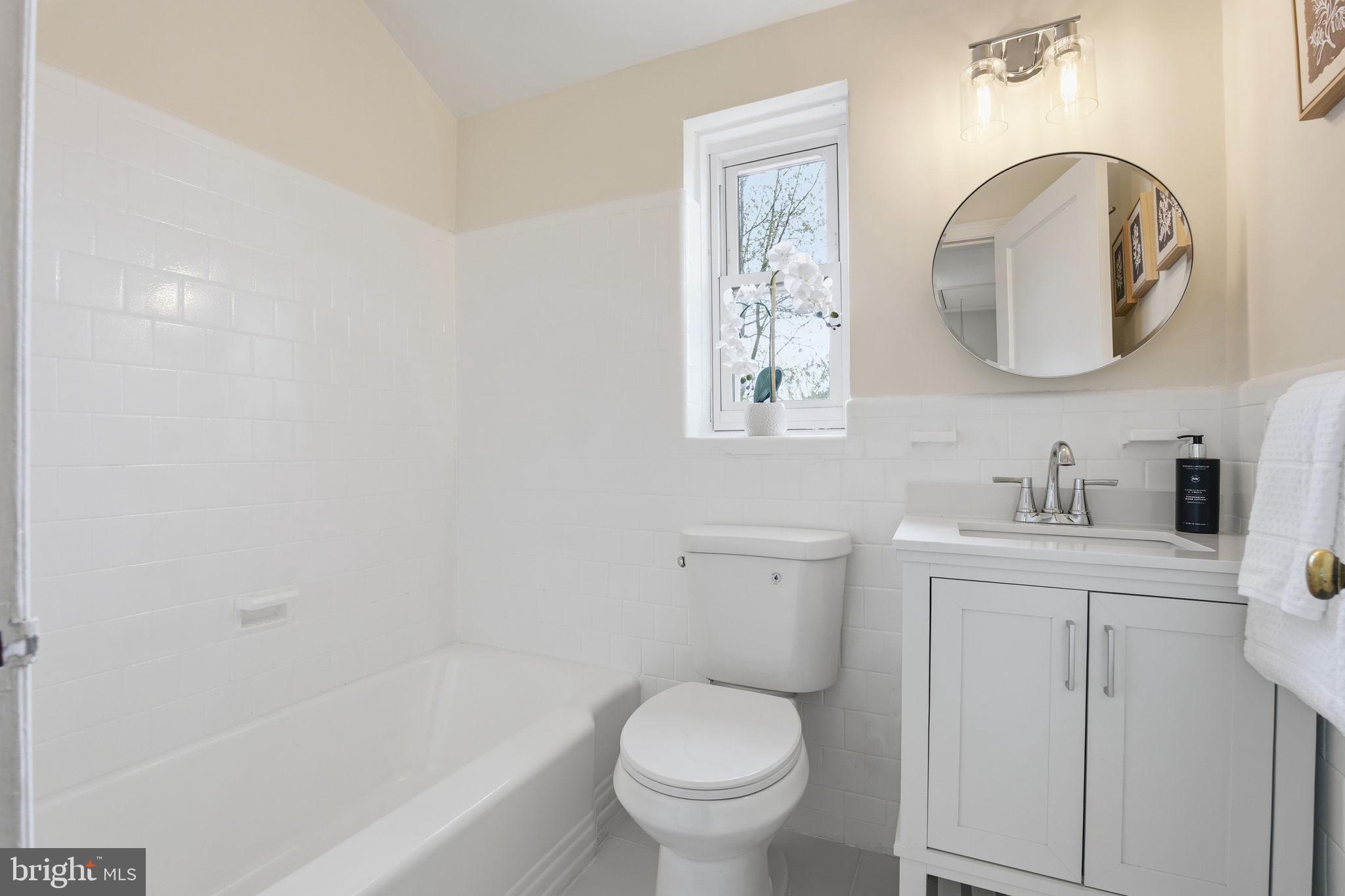 11527 Grandview Avenue Silver Spring, MD 20902 - Photo 23 of 36 a bathroom with a toilet sink and mirror