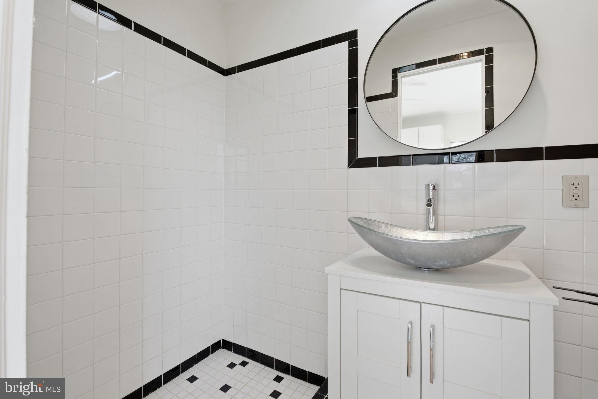 11527 Grandview Avenue Silver Spring, MD 20902 - Photo 24 of 36 a bathroom with a sink and a mirror