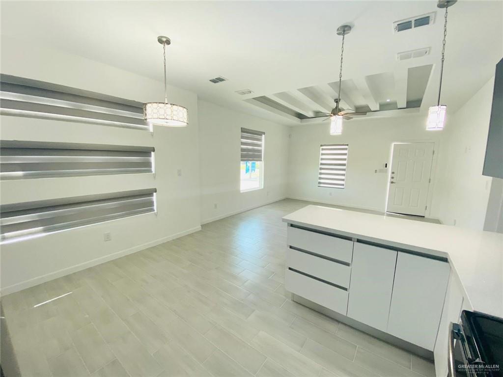 1621 Summit Drive, Unit 1 Pharr, TX 78577 - Photo 5 of 9 a room with a ceiling fan and a wooden floor