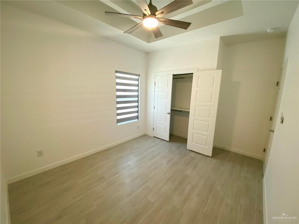 1621 Summit Drive, Unit 1 Pharr, TX 78577 - Photo 6 of 9 an empty room with closet and windows