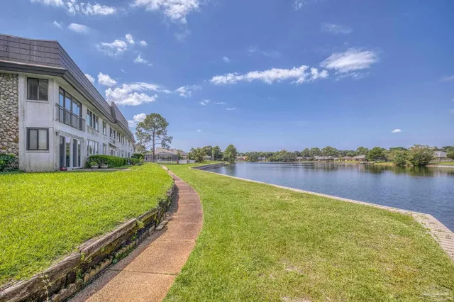 a view of a lake with a house in the background