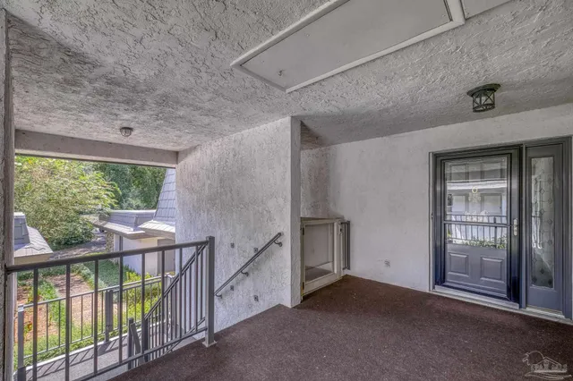 a view of an empty room with glass door