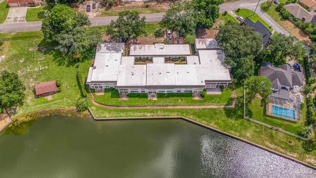 an aerial view of a house with a garden and swimming pool