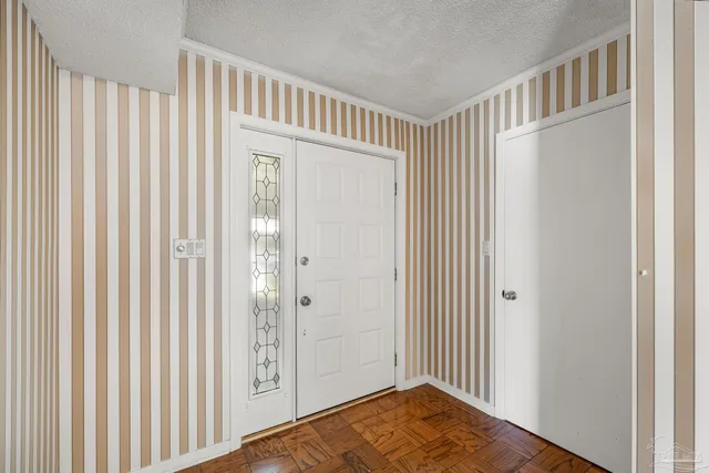 an empty room with wooden floor and window