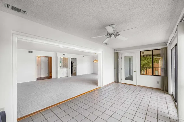 wooden floor in an empty room with a ceiling fan