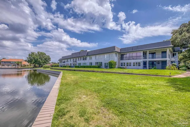 a front view of a house with yard and green space