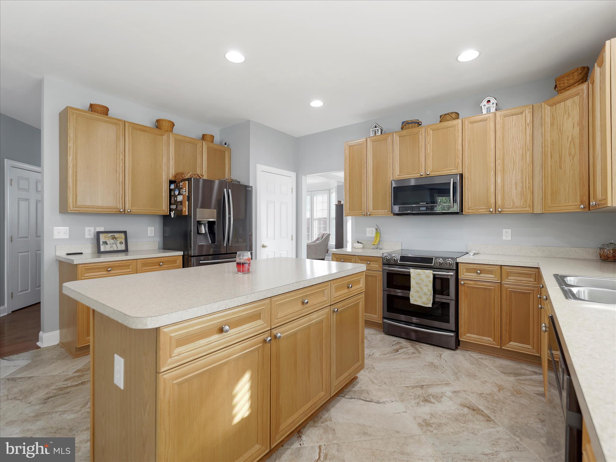 837 Triumphant Way Falling Waters, WV 25419 - Photo 29 of 66 a kitchen with kitchen island a sink stove and microwave
