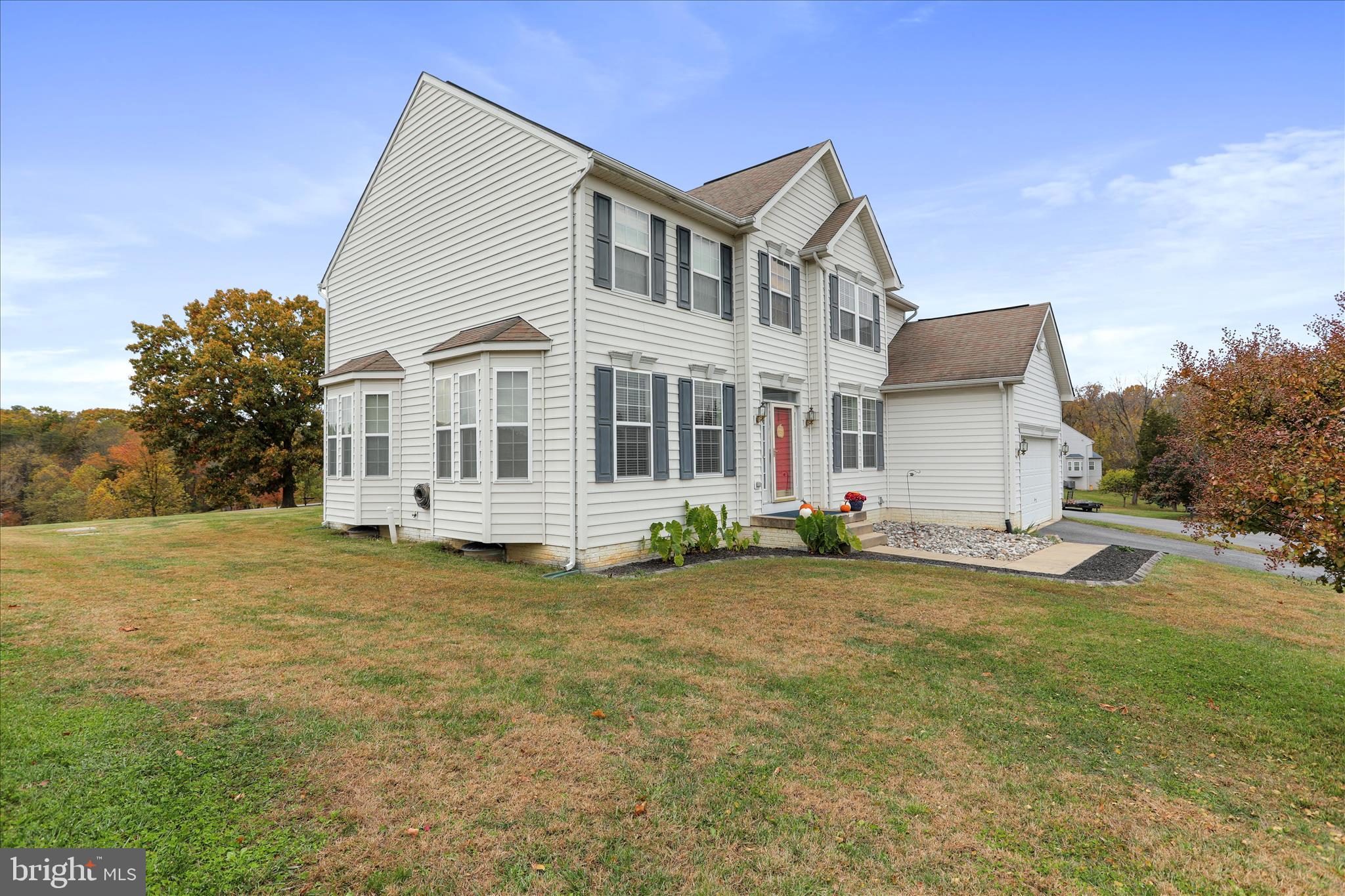 837 Triumphant Way Falling Waters, WV 25419 - Photo 4 of 66 a front view of a house with a garden and yard