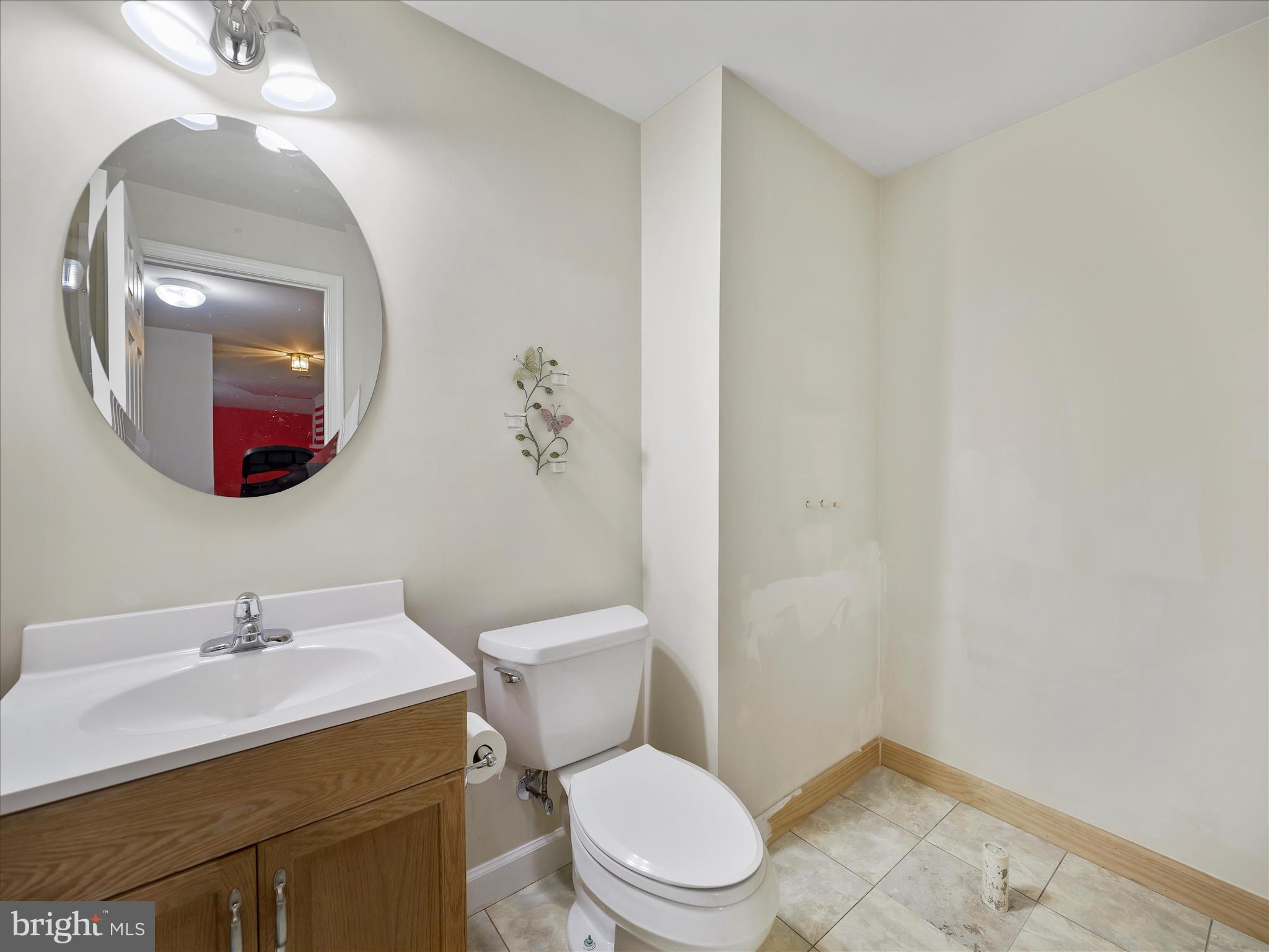 837 Triumphant Way Falling Waters, WV 25419 - Photo 61 of 66 a bathroom with a toilet a sink and mirror
