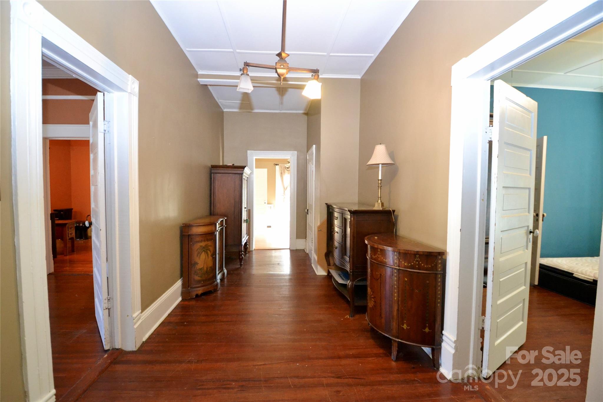 512 2nd Street Spencer, NC 28159 - Photo 29 of 33 a view of a hallway with dining room and wooden floor